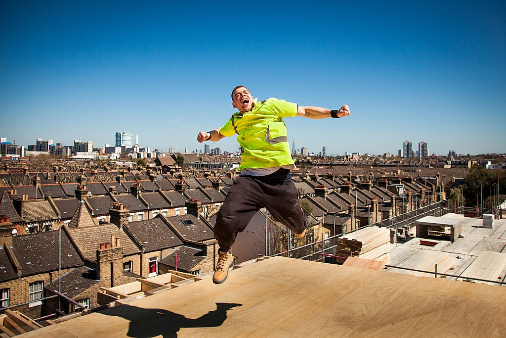 Happy and unsafe construction worker (Fall Hazard)