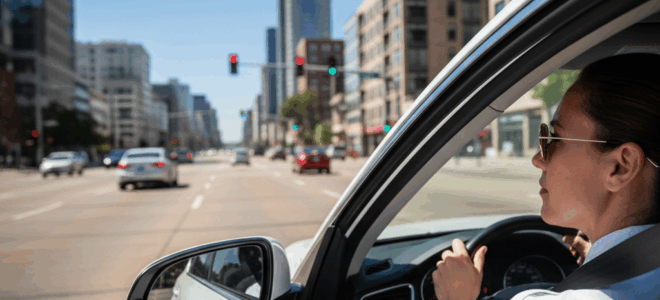 Driver practicing defensive driving to prevent car accidents on city roads